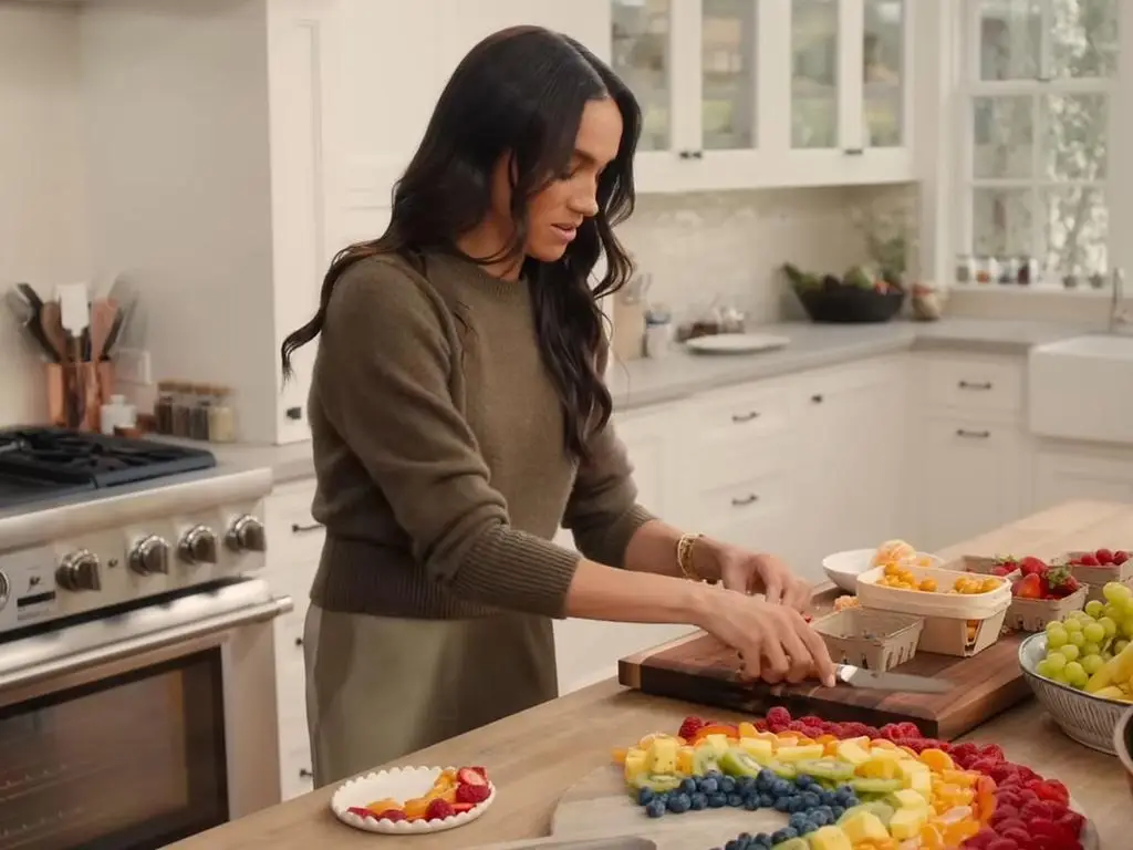 Meghan Markle arranging a rainbow fruit platter - known as the rainbow fruit platter fiasco